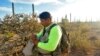 Oscar Andrade prays, Sept. 4, 2022, in the Ironwood Forest National Monument near Marana, Ariz., before searching for a missing Honduran migrant. The pastor heads a group that provides recovery efforts for families of missing migrants.