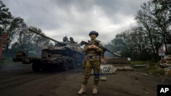 A Ukrainian serviceman stands at the checkpoint near the recently retaken area of Izium, Ukraine, Sept. 15, 2022.
