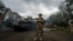 A Ukrainian serviceman stands at the checkpoint near the recently retaken area of Izium, Ukraine, Sept. 15, 2022.