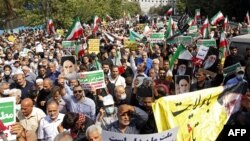 Iranians march during a pro-hijab rally in Tehran, Sept. 23, 2022. They paid tribute to security forces who have moved to quell a week of protests by what official media called "conspirators."