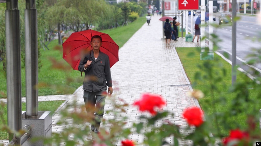 9月14日，一场降雨之后，人们在朝鲜首都平壤中心地区走路。(photo:VOA)