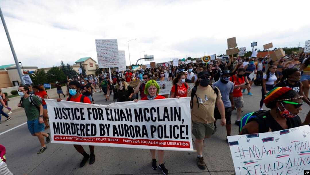 FILE - Demonstrators move along Interstate 225 after stopping traffic during a rally and march over the death of 23-year-old Elijah McClain, June 27, 2020, in Aurora, Colo.