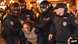 FILE - Police officers detain a man during a protest in Moscow, Sept. 21, 2022.