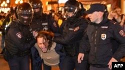 Police officers detain a man in Moscow on Sept. 21, 2022, following calls to protest against partial mobilization announced by President Vladimir Putin.