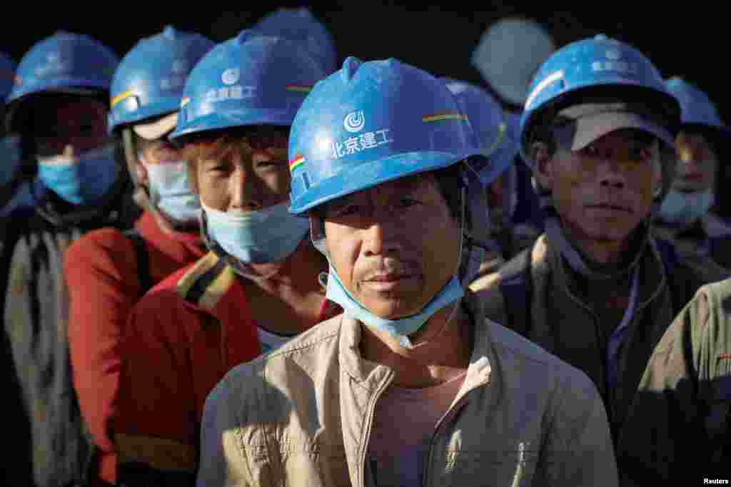 Workers gather to begin their day at the building site of the new Workers&#39; Stadium in Beijing, China.