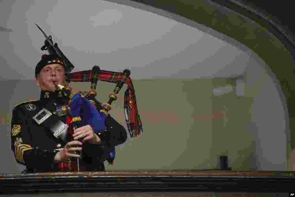 A piper plays during the funeral of Queen Elizabeth at Westminster Abbeyin London, Sept. 19, 2022. 