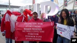 Fans of Swiss tennis legend Roger Federer react as they arrive at the O2 arena in London, Sept. 23, 2022 ahead of his doubles match with Team Europe's Rafael Nadal.