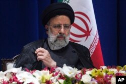 FILE - Iran President Ebrahim Raisi speaks at the United Nations General Assembly in New York, Sept. 22, 2022. Iran said Saturday it is reviewing its law requiring women to cover their heads.