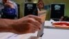 People wait to vote at a polling station in Rome, Italy, Sept. 25, 2022. 