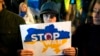 A boy holds a banner during a protest against the mobilization announced by Russian President Vladimir Putin in Belgrade, Serbia, Sept. 21, 2022.