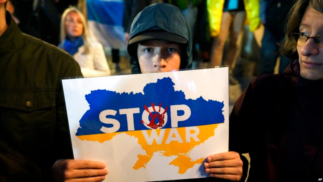 A boy holds a banner during a protest against the mobilization announced by Russian President Vladimir Putin in Belgrade, Serbia, Sept. 21, 2022.