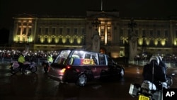 The coffin of Queen Elizabeth II in the royal hearse arrives at Buckingham Palace in London, Sept. 13, 2022.