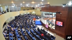 Visitors in the gallery view the courtroom during Khieu Samphan's, the former head of state for the Khmer Rouge, hearing takes place at the U.N.-backed war crimes tribunal in Phnom Penh, Cambodia, Thursday, Sept. 22, 2022. (Nhet Sok Heng/Extraordinary Chambers in the Courts of Cambodia via AP)