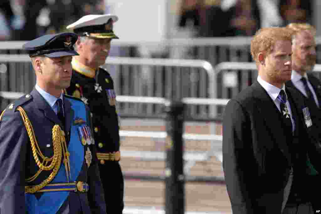 Prince Harry and Prince William follow the coffin of Queen Elizabeth II during a procession from Buckingham Palace to Westminster Hall in London, Sept. 14, 2022.