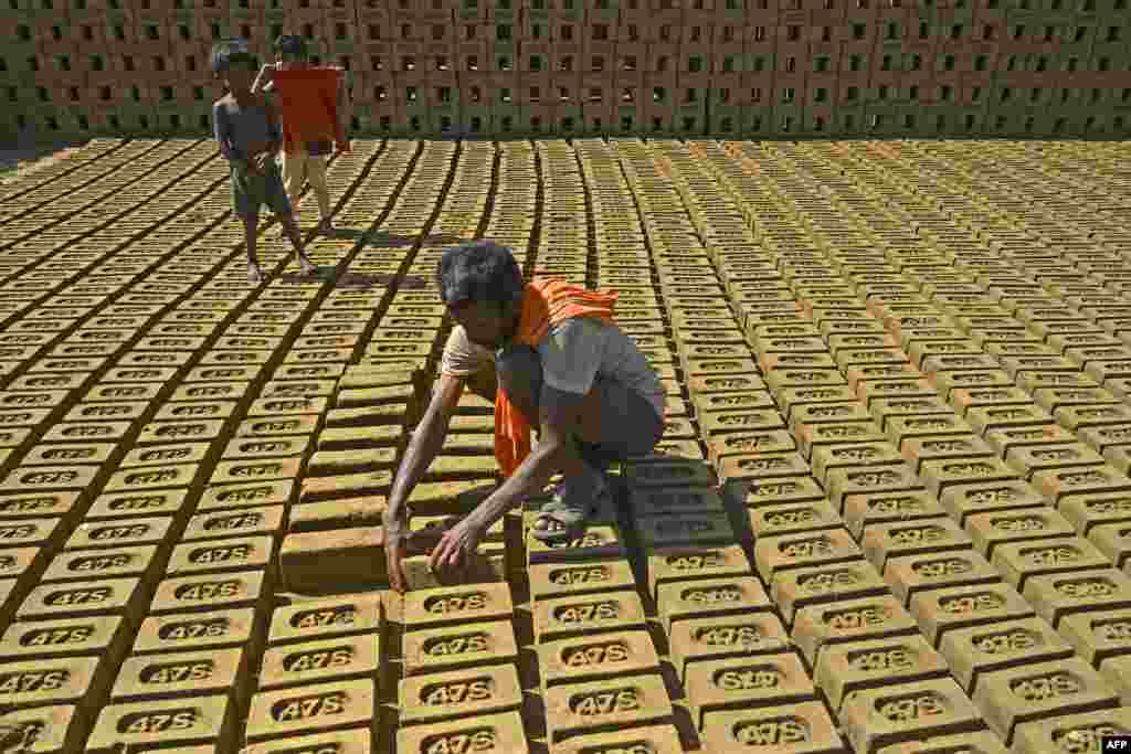 A laborer works at a brick kiln on the outskirts of Srinagar, India.