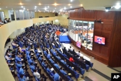 Visitors in the gallery view the courtroom during the hearing of Khieu Samphan, the former head of state for the Khmer Rouge, at the U.N.-backed war crimes tribunal in Phnom Penh, Cambodia, Sept. 22, 2022.