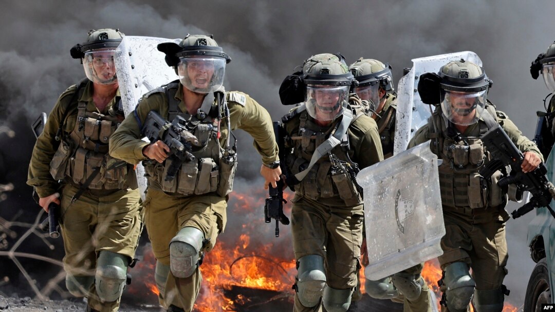 Pasukan keamanan Israel berlari ke arah demonstran Palestina selama bentrokan menyusul protes terhadap pengambilalihan tanah Palestina oleh Israel di desa Kfar Qaddum, Tepi Barat, wilayah Palestina yang diduduki Israel (foto: dok). 
