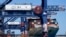 FILE - A container ship is unloaded at Port Botany in Sydney, Australia, Oct. 5, 2021. 