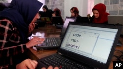 FILE - In this Sunday, Jan. 21, 2018 photo, Afghan women receive computer training center in Herat province, western Afghanistan. (AP Photo/Ahmad Seir)