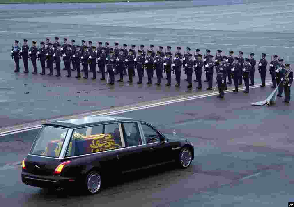 The hearse carrying the coffin of Queen Elizabeth II departs RAF Northolt, London, where it will be taken to Buckingham Palace.