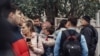 A woman hugs a boy surrounded by other people near the scene of a shooting at a school in Izhevsk, Russia, Sept. 26, 2022.