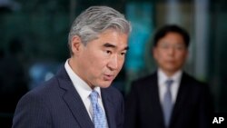 FILE: U.S. Special Representative for North Korea, Sung Kim, speaks after a meeting with South Korea's Special Representative for Korean Peninsula Peace and Security Affairs Noh Kyu-duk, back right, Oct. 18, 2021, at the U.S. State Department.