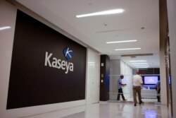 FILE - Staff enter the headquarters of information technology firm Kaseya in Miami, in an undated still image from video.