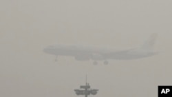 An Air China passenger plane prepares to land at Beijing's Capital International Airport as heavy pollution covers the capital, on Dec. 21, 2016.