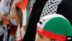 Bahraini children carrying Palestinian flags and wearing Palestinian-style scarves 