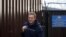 FILE - Russian opposition leader Alexei Navalny walks out of a detention center after he was jailed for 30 days for calling an unauthorized protest in Moscow, Aug. 23, 2019.