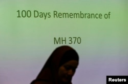 A family member of a Malaysian passenger on board the missing Malaysia Airlines Flight 370 attends the 100 Days Remembrance of MH370 ceremony in Kuala Lumpur, Malaysia, June 15, 2014.