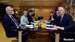 From left, Britain's Secretary of State for Exiting the European Union David Davis, Britain's Prime Minister Theresa May, European Commission President Jean-Claude Juncker and European Union's chief Brexit negotiator Michel Barnier meet at the European Commission in Brussels, Belgium, Dec. 8, 2017.