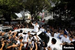 FILE - Former general and head of the Gerinrda Party Prabowo Subianto speaks to supporters after registering himself and his running mate, former Jakarta Deputy Governor Sandiaga Uno, as candidates for the 2019 presidential election outside the General Election Commission in Jakarta, Indonesia, Aug. 10, 2018.