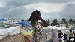 A woman stands next to makeshift tents at a camp set up for earthquake survivors left homeless in Port-au-Prince, one month after a magnitude 7 earthquake struck Haiti, Feb 2010 (file photo)