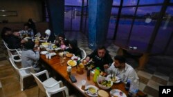 FILE—Residents displaced from their homes in southern Lebanon by clashes on the border with Israel eat during the Muslim's holy fasting month of Ramadan, at an abandoned hotel being used as a shelter in the southern town of Marwanieh, Lebanon, March 15, 2024.