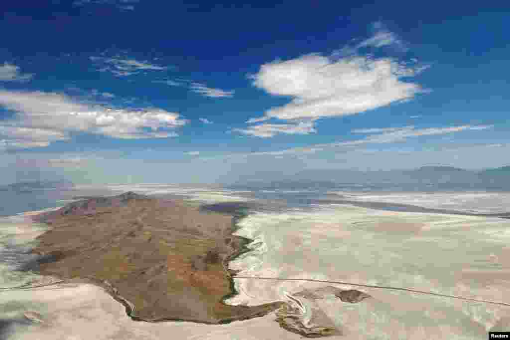 Dry land surrounds Antelope Island, where there used to be water in the Great Salt Lake, in Salt Lake City, Utah, July 13, 2022.