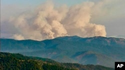 Smoke plumes from the McKinney Fire are seen July 30, 2022, from a California Department of Forestry and Fire Protection, Cal Fire, outdoor camera called Antelope Mt./Yreka. (California Department of Forestry and Fire Protection/Cal Fire via AP)