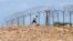 FILE: A Zimbabwean man flees across border near Beitbridge Border Post in Musina, South Africa, Friday March 28, 2008. Zimbabwe goes to the polls on Saturday amid growing international concern that President Robert Mugabe intends to manipulate the vote. (AP Photo/Themba Hadebe)