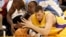 FILE - Los Angeles Lakers' Slava Medvedenko, right, of Ukraine, and Denver Nuggets' Francisco Elson, top, of the Netherlands, dive for the ball in the first quarter of a preseason NBA basketball game in Los Angeles, California, Oct. 20, 2005.