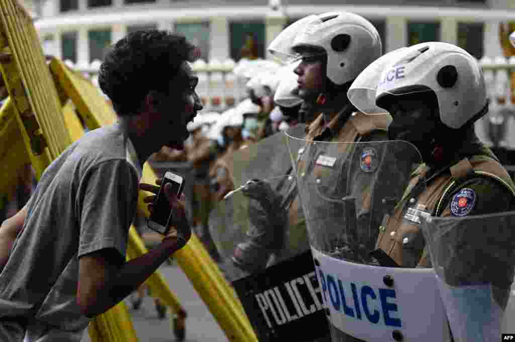 A demonstrator interacts with Sri Lankan police blocking anti-government marchers from walking to&nbsp;the Presidential secretariat office in Colombo, Sri Lanka.