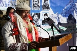 FILE - Nepal's climber Nirmal Purja delivers a speech upon his arrival for a welcome ceremony after becoming with his team, the firsts to summit Pakistan's K2 in winter, Shigar district in Gilgit-Baltistan region of northern Pakistan, Jan. 20, 2021.