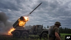 Ukrainian weaponry shoots toward Russian positions at the front line in Kharkiv region, Ukraine, Aug. 2, 2022.
