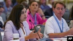 FILE - Colorado Secretary of State Jena Griswold talks about recent threats against her in Colorado during a committee meeting about threats at the summer conference of the National Association of Secretaries of State in Baton Rouge, Louisiana, July 8, 2022.