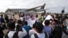 FILE - Journalists surround donated COVID-19 vaccines at the Phnom Penh International Airport in Phnom Penh, Cambodia, July 30, 2021. A report by a U.N. human rights agency finds increasing restrictions being placed on journalists, some related to COVID-19 measures.