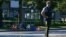 A police officer stands near a bicycle lying on the ground after authorities alerted residents of multiple shootings targeting transient victims in the Vancouver suburb of Langley, British Columbia, Canada July 25, 2022. 