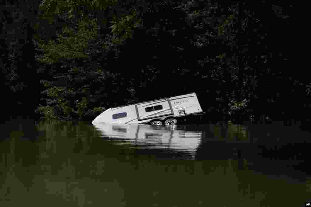 A camper is seen partly submerged under water in Carr Creek Lake, Aug. 3, 2022, near Hazard, Kentucky.