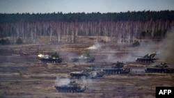 This handout video grab released by the Russian Defense Ministry on Feb. 21, 2022, shows Russian and Belarus tanks during joint exercises near Brest, Belarus.