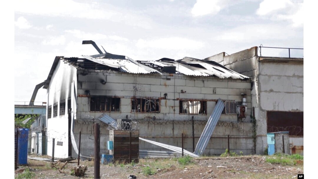 This frame from a video shows a destroyed barracks at a prison in Olenivka, in an area controlled by Russian-backed separatist forces, eastern Ukraine, July 29, 2022. Russia and Ukraine accused each other Friday of shelling the prison.