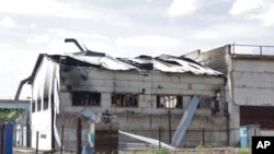 This frame from a video shows a destroyed barracks at a prison in Olenivka, in an area controlled by Russian-backed separatist forces, eastern Ukraine, July 29, 2022. Russia and Ukraine accused each other Friday of shelling the prison.