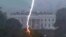 A lightning strike hits a tree in Lafayette Park across from the White House during an evening thunderstorm, as seen in this frame grab from a Reuters TV video camera mounted on a nearby rooftop in Washington, Aug. 4, 2022.